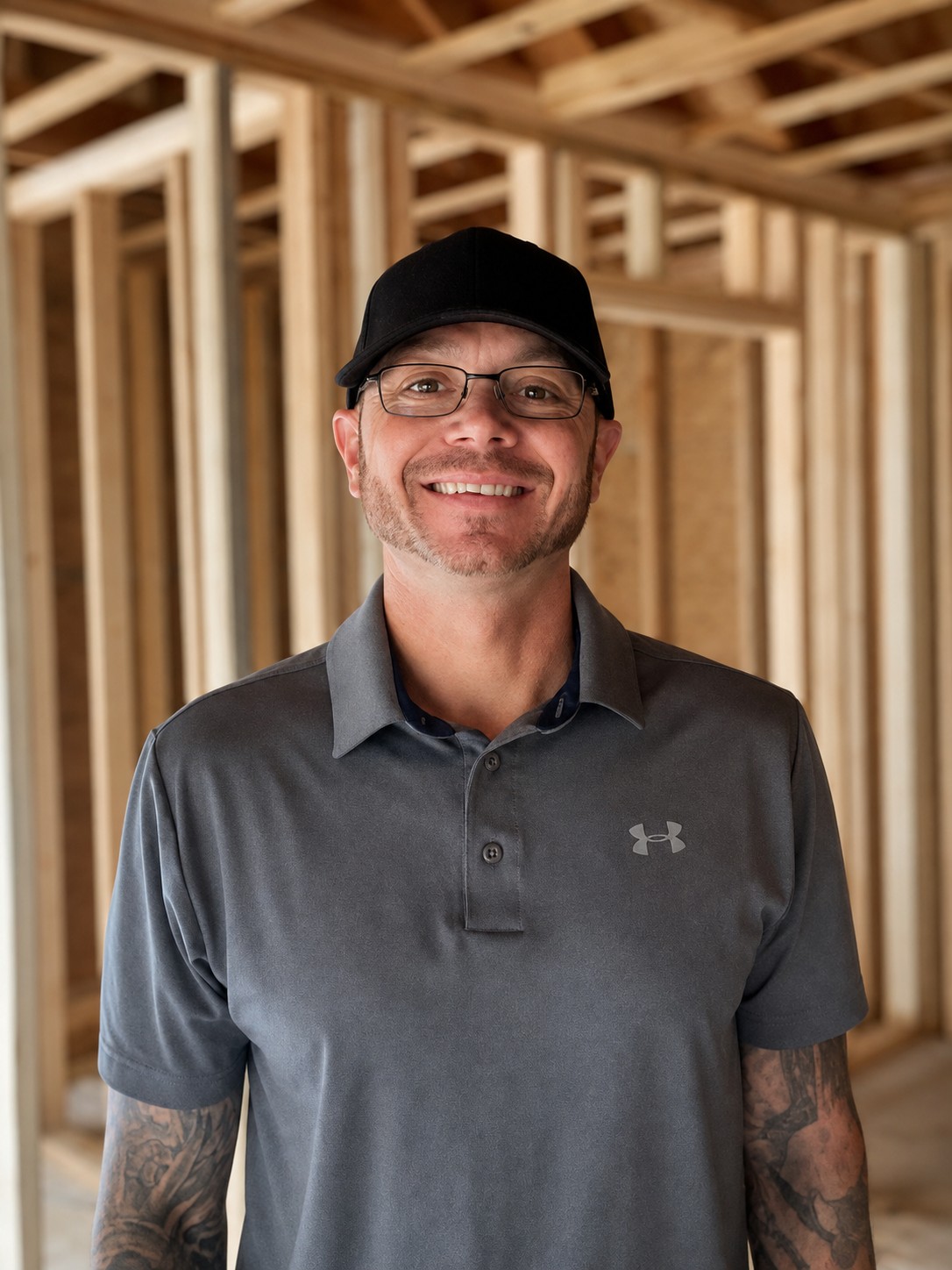 D. Maher, owner of The Carpenter Coach, standing in a framed home addition